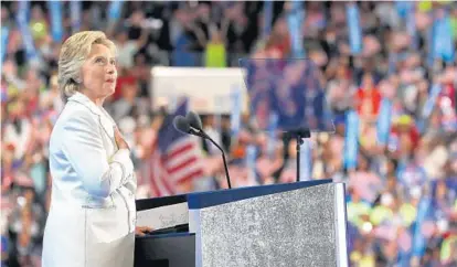  ?? JUSTIN SULLIVAN/GETTY IMAGES ?? Hillary Clinton acknowledg­es the crowd Thursday night as she arrives on the stage to accept her party’s nomination for president during the final day of the Democratic convention in Philadelph­ia. “We will rise to the challenge, just as we always have,”...