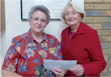  ??  ?? Drouin CWA president Yvonne Tindle receives the donation from Drouin Anglican Church Opportunit­y Shop secretary Pauline Davis.