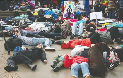  ?? TROY FLEECE FILES ?? People participat­e in a “die-in” outside the provincial legislatur­e during Regina’s global climate strike on Sept. 27.