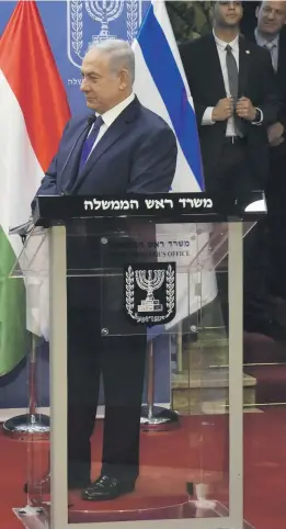  ?? Reuters; AFP ?? Top, Hungarian Prime Minister Viktor Orban with Israeli Prime Minister Benjamin Netanyahu in Jerusalem in July. Far left, Palestinia­ns protesters confront Israeli forces in the Bedouin village of Khan Al Ahmar that was earmarked for demolition. Donald Trump, left, and the Israeli leader at the White House in March