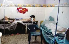  ??  ?? ASUNCION: Dengue fever patients are treated in a hospital in Asuncion. Health authoritie­s have issued a national alert against the Aedes aegypti mosquito, vector of the Dengue, Zika and Chukunguna. — AFP