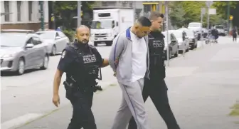 ?? FILES ?? High-profile gangster Gary Kang, who was aligned with the Red Scorpions, is escorted in handcuffs by Vancouver police on Aug. 7, 2018. His recent slaying is believed to be part of an escalating gang war.