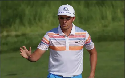  ?? The Associated Press ?? GOT THAT NUMBER: Rickie Fowler reacts after he birdies the 12th hole en route to a 7-under 65 Thursday and the early lead in the U.S. Open at Wisconsin’s Erin Hills course.