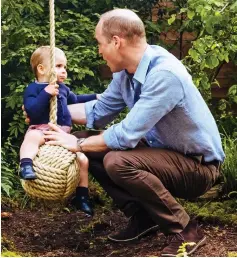  ??  ?? Holding tight: William helps Louis try the rope-ball...