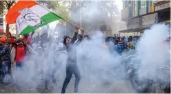  ?? — PTI ?? A Congress worker waves the party flag to celebrate the party’s performanc­e in Assembly elections in Rajasthan, Chhattisga­rh and Madhya Pradesh, in Jabalpur on Tuesday.