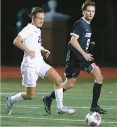  ?? STEPHEN M. DOWELL/ORLANDO SENTINEL ?? Trinity Prep’s Henry Brown, left, and Bishop Moore’s Alexander Pencak chase after the ball during a boys soccer regular-season showdown Jan. 18. Both teams play in separate FHSAA regional championsh­ip games Wednesday.