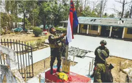  ?? REUTERSPIC ?? A KNLA fighter raises the Karen national flag at Thingyan Nyi Naung village on the outskirts of Myawaddy on Monday. –