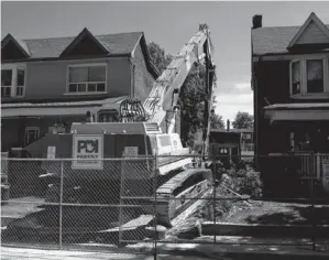  ?? PHOTOS BY TYLER ANDERSON / NATIONAL POST ?? A house on Maria Street leans on Thursday, top, and is demolished on Friday, bottom.