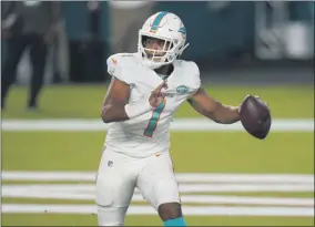  ?? LYNNE SLADKY - THE ASSOCIATED PRESS ?? Miami Dolphins quarterbac­k Tua Tagovailoa (1) looks to pass during the second half of an NFL football game against the New York Jets, Sunday, Oct. 18, 2020, in Miami Gardens, Fla.