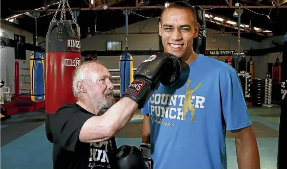  ??  ?? Derrick Depledge takes a swing at his grandson, boxer David Nyika.