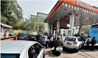  ?? PTI ?? People at a petrol pump in New Delhi on Wednesday