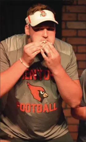  ?? PAUL DICICCO — THE NEWS-HERALD ?? Mentor’s Ryan Jacoby competes in The News-Herald/Varsity Chalk Talk hot dog eating contest July 16 at Hooley House in Mentor.