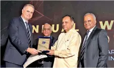  ??  ?? Koenraad Pringiers receives a merit award from Speaker Karu Jayasuriya. Others in the picture are Ananda Caldera, Chairman Admin and Finance Sub-committee, (second from left) and Kaushal Rajapaksa, President, PRISL (fourth from left).