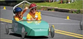  ??  ?? Kids zoomed down Wilson Street Saturday during the Soap Box Derby Challenge race. Children with special needs were given the opportunit­y to compete with a co-driver in a race similar to the Pottstown Soap Box Derby.