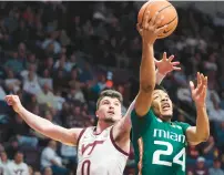  ?? RYAN HUNT/GETTY ?? Miami guard Nijel Pack shoots past Virginia Tech guard Hunter Cattoor during Tuesday night’s game in Blacksburg.