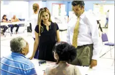  ?? VINCENT OSUNA PHOTO ?? El Centro residents Julio and Lyli Rodriguez prepare to vote during the 2018 Primary Election on Tuesday at Central Baptist Church in El Centro.