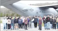  ?? Westside Eagle Observer/MIKE ECKELS ?? Students at Decatur High School take a moment for a photo in front of the Lockheed C-130 cargo transport aircraft during a tour of the Arkansas Air and Military Museum at Drake Field in Fayettevil­le Thursday morning. The group, touring the four buildings that make up the museum complex, learned a little about aviation and military history during the two-hour visit.