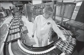  ?? PROVIDED TO CHINA DAILY ?? A Danone employee works at a yogurt production line in Moscow.