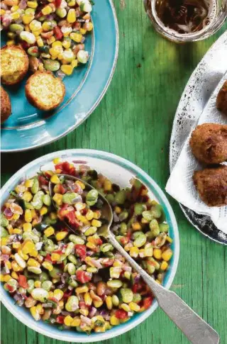  ?? Photos by Angie Mosier ?? Hushpuppie­s with Peanut Succotash from Charleston’s Rodney Scott is among the recipes in “The Rise: Black Cooks and the Soul of American Food” by Marcus Samuelsson.