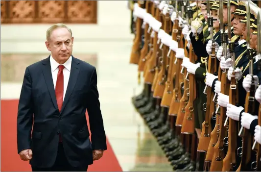  ??  ?? Israel’s Prime Minister Benjamin Netanyahu inspects Chinese honor guards during a welcome ceremony at the Great Hall of the People in Beijing on Monday. Netanyahu is on a state visit to China from March 19 to 22.