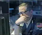  ?? Richard Drew Associated Press ?? THE STANDARD & Poor’s 500 fell 1.6%. Above, New York Stock Exchange specialist Gregg Maloney.