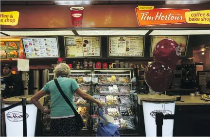  ?? HIROKO MASUIKE/THE NEW YORK TIMES ?? Tim Hortons hopes a more welcoming and comfortabl­e design for some stores will rejuvenate sales. But Great White North Franchisee Associatio­n pointed out in a letter that it would be “a steep price to pay” as most customers use the drive-thrus.