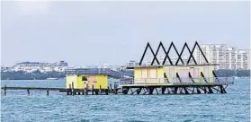  ?? ALAN DIAZ/AP ?? Top: One of Stiltsvill­e’s getaway shacks, perched over Biscayne Bay off the coast of Miami. Above: Photo taken Oct. 21 shows one of the shacks after Hurricane Irma.