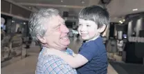  ?? PHOTO: GETTY IMAGES ?? Ttktktktk . . . Alan Kinkade, of Sydney, reunites with his grandson Tom, who lives in Melbourne, after six months of separation, at Sydney domestic airport yesterday.