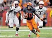  ?? Adrian Kraus Associated Press ?? SYRACUSE running back Jarveon Howard carries against Louisville. The Orange won 54-23.