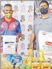  ?? Picture: FIJI FA MEDIA ?? Kaiava Rawaqa, left, with his food packs donated by Fiji Football Associatio­n.