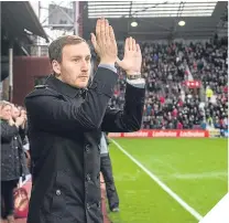  ??  ?? ■ Hearts boss Ian Cathro applauds the fans.