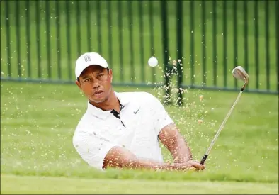  ?? Christian Petersen / Getty Images ?? Tiger Woods plays a shot out of the bunker during a practice round Tuesday before the PGA Championsh­ip at Southern Hills Country Club in Tulsa, Okla.