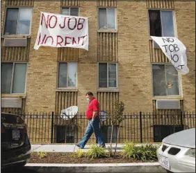  ?? ANDREW HARNIK / ASSOCIATED PRESS FILE (2020) ?? Signs that read “No Job No Rent” hang from the windows of an apartment building May 20, 2020, during the coronaviru­s pandemic in northwest Washington. In addition to killing 600,000 in the United States and afflicting an estimated 3.4 million or more with persistent symptoms, the pandemic threatens the health of vulnerable people devastated by the loss of jobs, homes and opportunit­ies for the future.