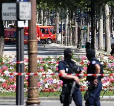  ?? (Reuters) ?? SHOULD ISRAEL learn how to fight terrorism from Europe? French police secure the area near the scene of a car ramming on the Champs-Elysees Avenue in Paris in June.