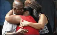  ?? ANDREW NELLES — THE TENNESSEAN ?? Leshea White and Kimberly Stallworth hug their uncle Roger Bracey, who was at Burnette Chapel Church of Christ when shots were fired Sunday in Antioch, Tenn. They were reunited at another nearby church.