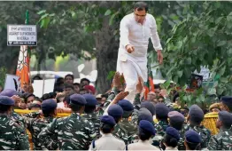  ?? — PTI ?? BJP MP Parvesh Verma stands on a police barricade during the party’s Jan Raksha Yatra protest against the alleged killing of RSS and BJP workers in Kerala, outside the CPI(M) office in New Delhi on Thursday.