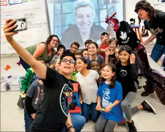  ?? Herald photo by Ian Martens ?? Teacher Ana Rebolone Morrison and her Grade 4/5 class pose for a selfie at the end of a Skype session with Jon Bon Jovi at École Agnes Davidson School.