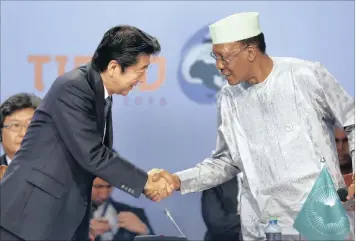  ??  ?? Japanese Prime Minister Shinzo Abe (left) shakes hands with Chadian President and chairman of the AU Idriss Déby (right) after he delivered a speech during the Opening Session of the Sixth Tokyo Internatio­nal Conference on African Developmen­t in Nairobi.