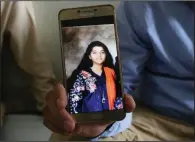  ?? AP/FAREED KHAN ?? “She was a great soul,” Aziz Sheikh said Saturday of his daughter Sabika. He shows her picture on a phone at their home in Islamabad.