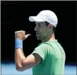  ?? MARK BAKER — THE ASSOCIATED PRESS ?? Defending men’s champion Serbia’s Novak Djokovic gestures during a practice session on Margaret Court Arena ahead of the Australian Open tennis championsh­ip in Melbourne, Australia, Thursday.