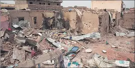  ?? ?? A man walks by a house hit in recent fighting in Khartoum, Sudan, on April 25, 2023.