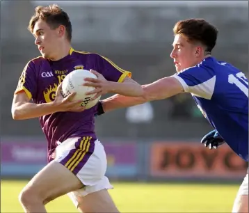  ??  ?? Niall Connolly of Wexford races away from Damon Larkin (Laois) in the Leinster MFC game on Wednesday.