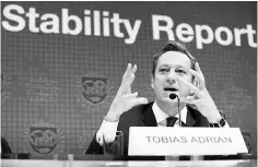  ??  ?? Internatio­nal Monetary Fund financial counsellor and director Tobias Adrian answers questions at the Global Financial Stability Report press conference on October 11, at the IMF Headquarte­rs in Washington, DC. — AFP photo