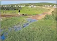  ?? Picture: TREMAINE VAN AARDT ?? ROADS UNUSABLE: One of several streams that run through Khayamnand­i township