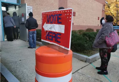  ?? NANCY LANE / HERALD STAFF FILE ?? VOTING IRREGULARI­TIES: Voters wait in line at a polling site on November 3, 2020, in Chelsea. Three write-in candidates vied for a spot on the Republican State Committee in a March 3, 2020, election, and a recount for the Second Suffolk District only recently turned up more than 120 extra votes.