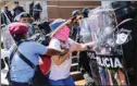  ??  ?? A Nicaraguan woman is arrested by riot police during a protest against the government of President Daniel Ortega in Managua on Sunday.