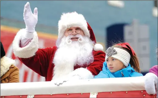  ??  ?? File Photo Santa Claus waves during the 2016 Christmas parade on the Bentonvill­e square. This year’s parade is scheduled for 11 a.m. Dec. 9.