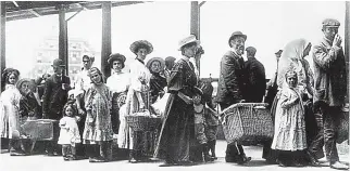  ??  ?? Arrivals: Immigrants wait in line after disembarki­ng at Ellis Island in 1905