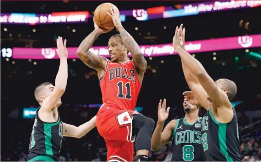  ?? MICHAEL DWYER/AP ?? DeMar DeRozan, who had 23 points, looks to dish off against Boston’s Payton Pritchard (left), Josh Richardson (8) and Al Horford in the first half.