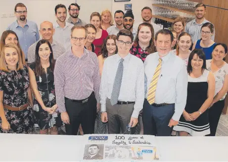  ??  ?? GOING STRONG: The Townsville staff of PVW Partners with the cake to celebrate the centenary of the firm.